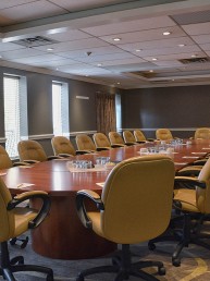 Board room set up with chairs around an oval table