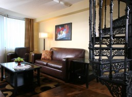 regal room, stair case and couch