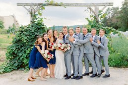 bride and groom with bridal party in garden